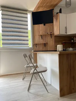 a kitchen with two chairs in front of a counter at Stay for 2 in Jajce