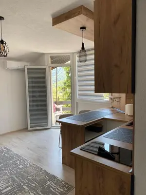 a kitchen with wooden cabinets and a counter top at Stay for 2 in Jajce