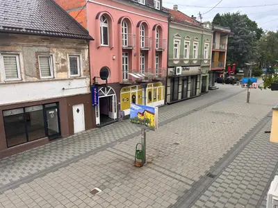 an empty street in a town with colorful buildings at Apartman EM Bugojno in Bugojno