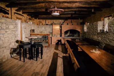 a room with a bar and a stone wall at Kuca za odmor Lovric
