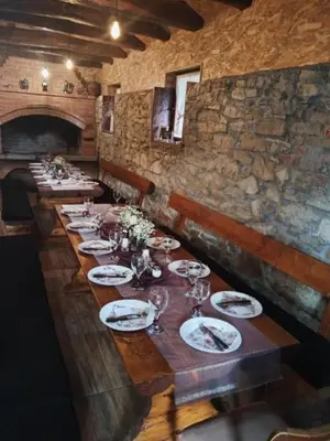 a long wooden table with plates and wine glasses at Kuca za odmor Lovric