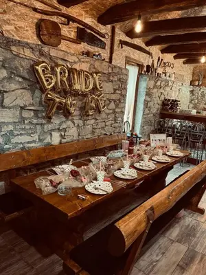 a long wooden table with plates of food on it at Kuca za odmor Lovric