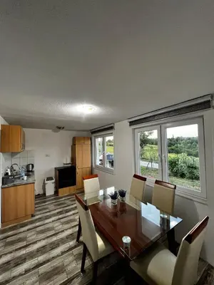 a kitchen and dining room with a table and chairs at Villa Melek in Bihać