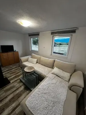 a living room with a couch and a table at Villa Melek in Bihać