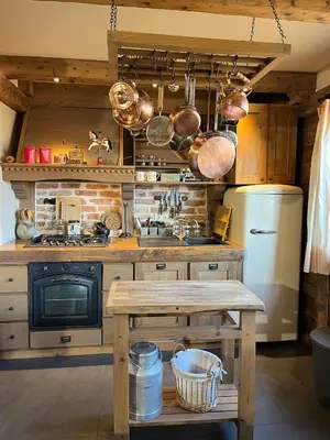 a kitchen with pots and pans hanging from the ceiling at Runolist Kupres in Kupres