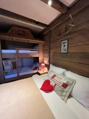 a bedroom with a bed with a red hat on it at Runolist Kupres in Kupres