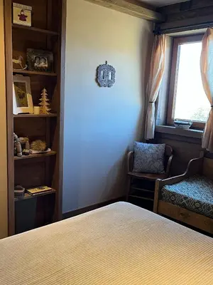 a bedroom with a bed and a window and a chair at Runolist Kupres in Kupres