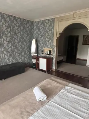 a bedroom with a bed and a room with a bed at Hotel New Milenium in Lukavac