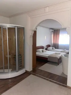 a large room with two beds and a bathroom at Hotel New Milenium in Lukavac