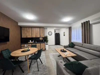 a living room with a couch and a table at Apartman Booem in Bihać