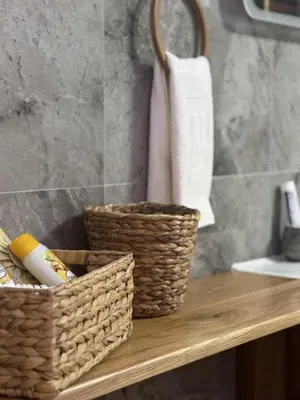 two baskets sitting on a wooden shelf in a bathroom at Apartman Booem in Bihać