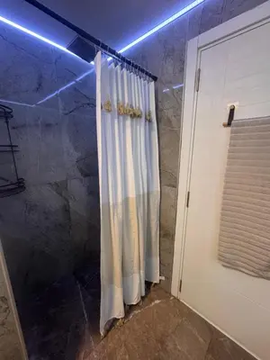 a bathroom with a shower with a shower curtain at Apartman Booem in Bihać