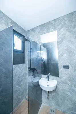 a bathroom with a sink and a shower at Vila Natalijina Ramonda in Banja Luka