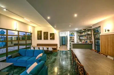 a living room with a blue couch and a table at Vila Natalijina Ramonda in Banja Luka