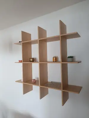 a wooden book shelf hanging on a wall at Guest House Puccallpah in Visoko