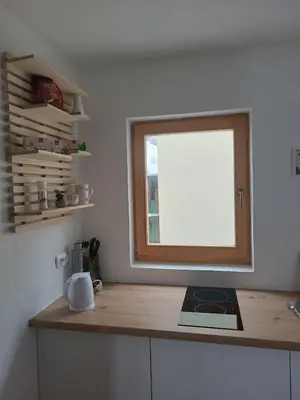 a window in a kitchen with a wooden counter top at Guest House Puccallpah in Visoko