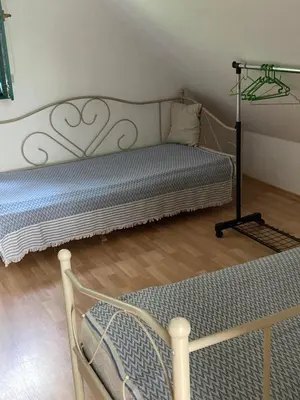 a bed in a room with a bed frame at Holiday Home Tunnel Ravne in Visoko