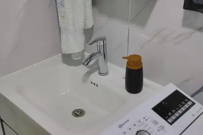a bathroom counter with a sink with aaucet at Tiny House Ljiljan in Bihać