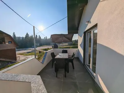 a balcony of a house with a table and chairs at Apartman Nermin 2 in Travnik