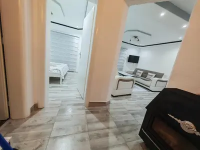 a room with a bed and a living room at Apartman Nermin 2 in Travnik