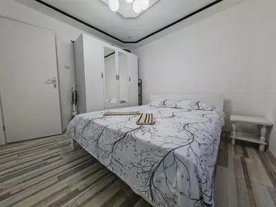 a bedroom with a bed with a table on it at Apartman Nermin 2 in Travnik
