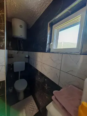a bathroom with a toilet and a window at Apartman Nermin 2 in Travnik