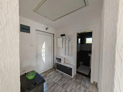 a bathroom with a walk in shower next to a door at Apartman Nermin 2 in Travnik