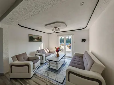 a living room with two couches and a table at Apartman Nermin 2 in Travnik