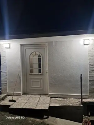 a white door on the side of a building at Apartman hukanovic in Bosanska Krupa