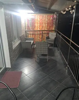 a room with chairs and tables and a window at Apartman hukanovic in Bosanska Krupa