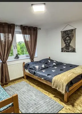 a bedroom with a bed and a window at Stan na dan Apartman Durakovic in Cazin