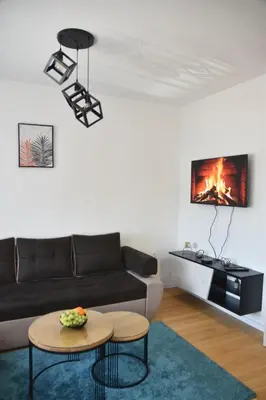 a living room with a couch and a table at Apartman Sweet in Prijedor
