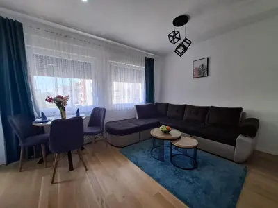 a living room with a couch and a table at Apartman Sweet in Prijedor