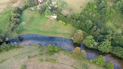an overhead view of a river in a field at Vikendica Sara in Šipovo