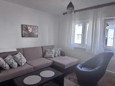 a living room with a couch and a chair at Casa SOLE in Bihać