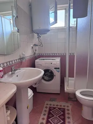 a bathroom with a washing machine and a washer at Casa SOLE in Bihać