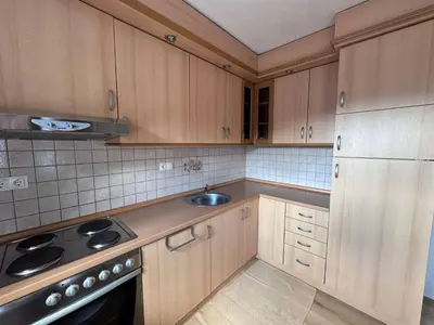a kitchen with wooden cabinets and a sink at Casa SOLE in Bihać