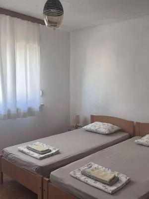 a room with two beds and a window at Casa SOLE in Bihać