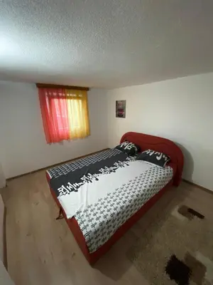 a bedroom with a bed in a room with a window at Anes House in Sokolac