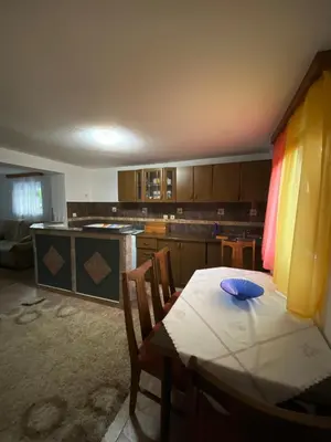 a kitchen with a table and chairs and a table and a kitchen at Anes House in Sokolac