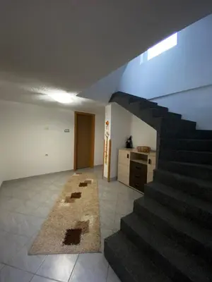 a living room with a staircase in a house at Anes House in Sokolac