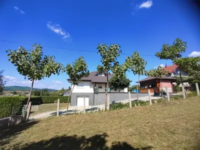 a house with a fence in front of a yard at Green Stay in Velika Kladuša