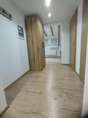 a hallway with a wooden door in a room at Green Stay in Velika Kladuša