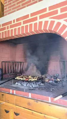 a brick oven with food cooking in it at Green Stay in Velika Kladuša