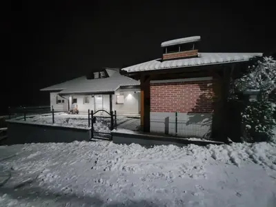 a house covered in snow at night at Green Stay in Velika Kladuša