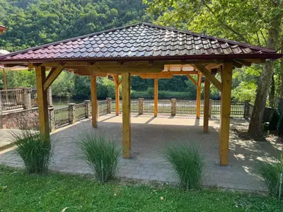 a wooden gazebo with a roof in a park at Villa Lavanda in Banja Luka