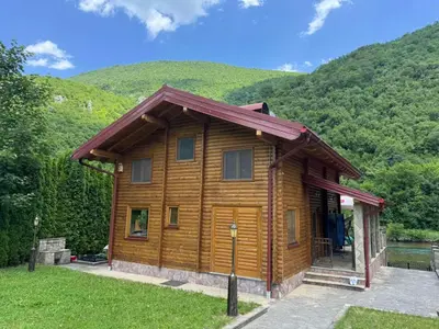 a wooden cabin with a red roof at Villa Lavanda in Banja Luka