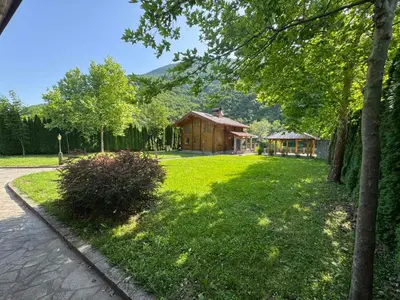 a large yard with a house in the background at Villa Lavanda in Banja Luka