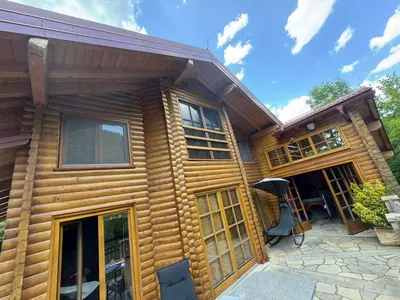 a log cabin with a front porch and a patio at Villa Lavanda in Banja Luka