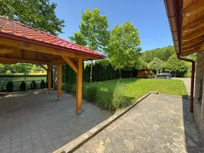 a patio with a red roof and a yard at Villa Lavanda in Banja Luka